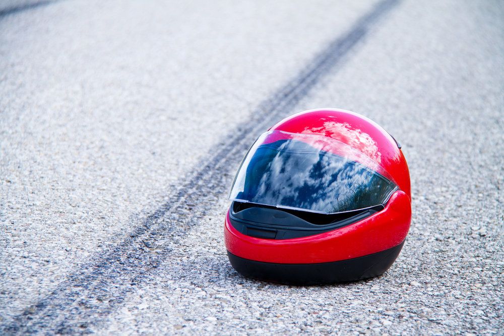 Red motorcycle helmet lying in street