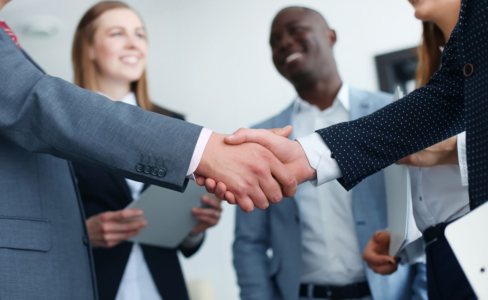 Group of business professionals shaking hands